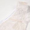 close-up of a beige lace garment with floral embroidery on a white background