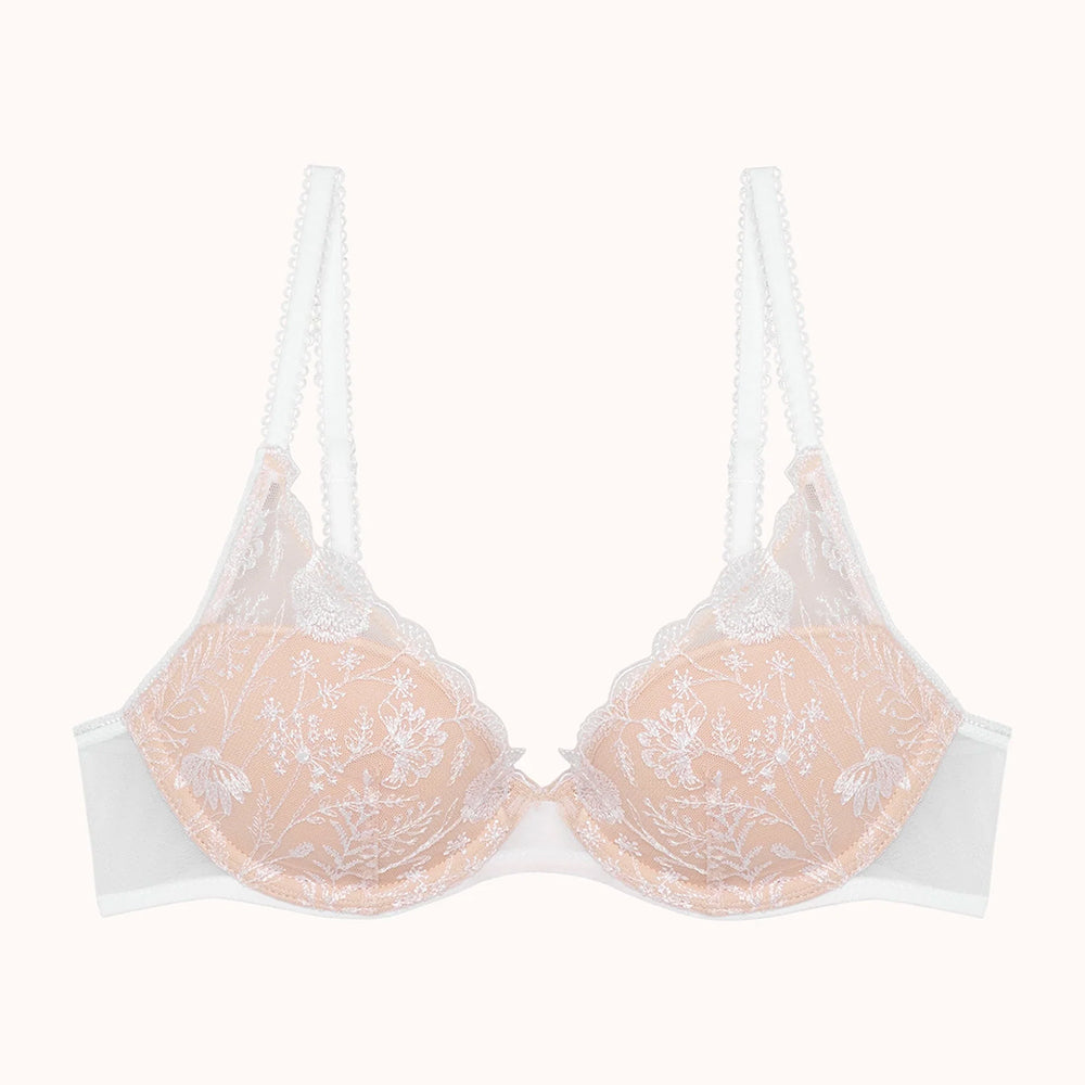nude bra with lace details on a white background