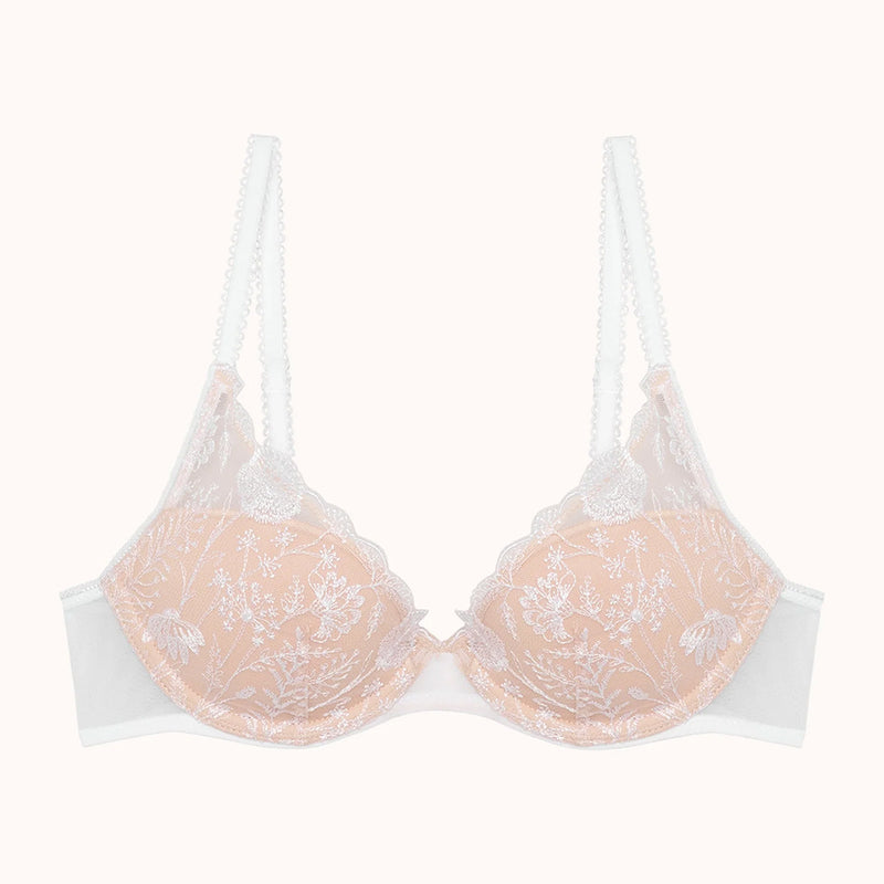 nude bra with lace details on a white background
