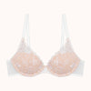 nude bra with lace details on a white background