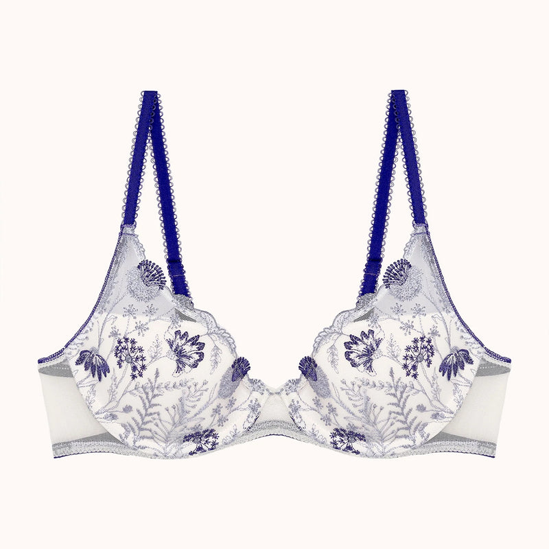 white bra with blue floral patterns and blue straps on a white background