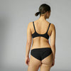 woman wearing a black bra and underwear set on a grey background