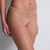 beige lace-trimmed underwear on a neutral background