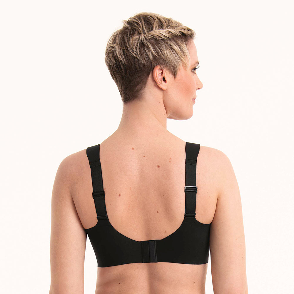 woman wearing a black sports bra on a white background