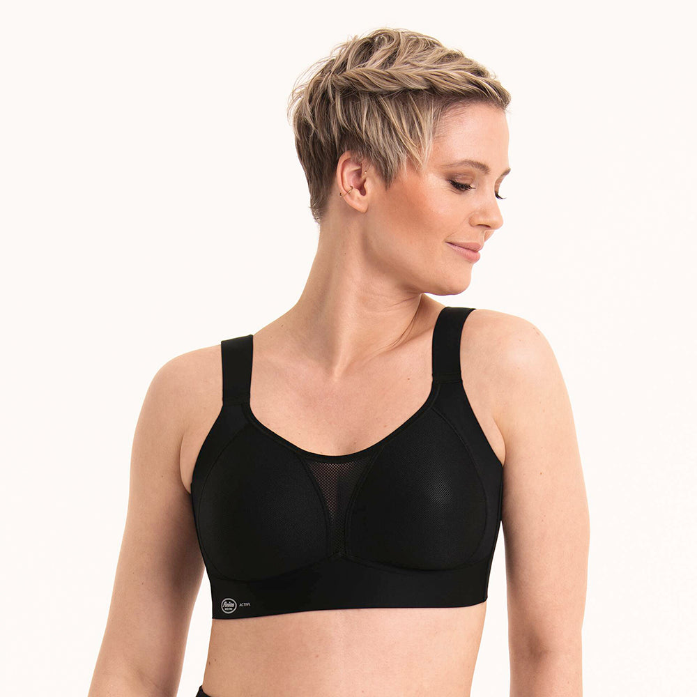 woman wearing a black sports bra on a white background