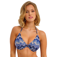 woman wearing a blue patterned bikini top on a white background