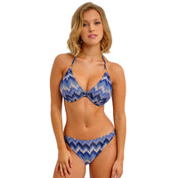woman wearing a blue and white patterned bikini on a white background