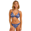 woman wearing a blue and white patterned bikini on a white background