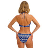 woman wearing a blue and white patterned bikini on a white background