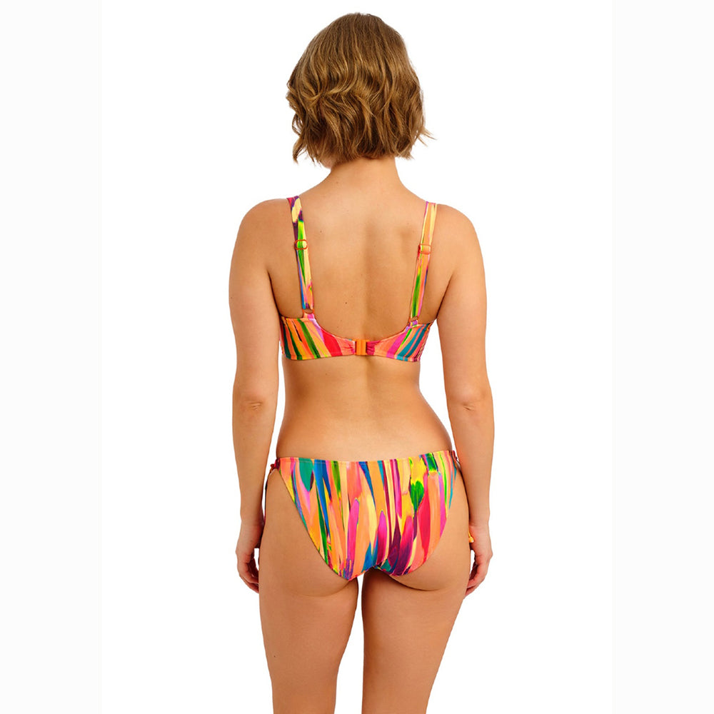 Woman wearing a colourful bikini set on a white background