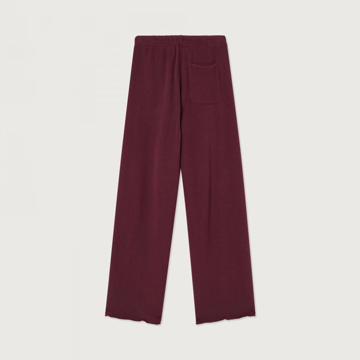 A pair of wide-leg knit pants in a deep burgundy color, featuring an elastic waistband and a single welt pocket on the back right leg, shown flat against a light off-white background.