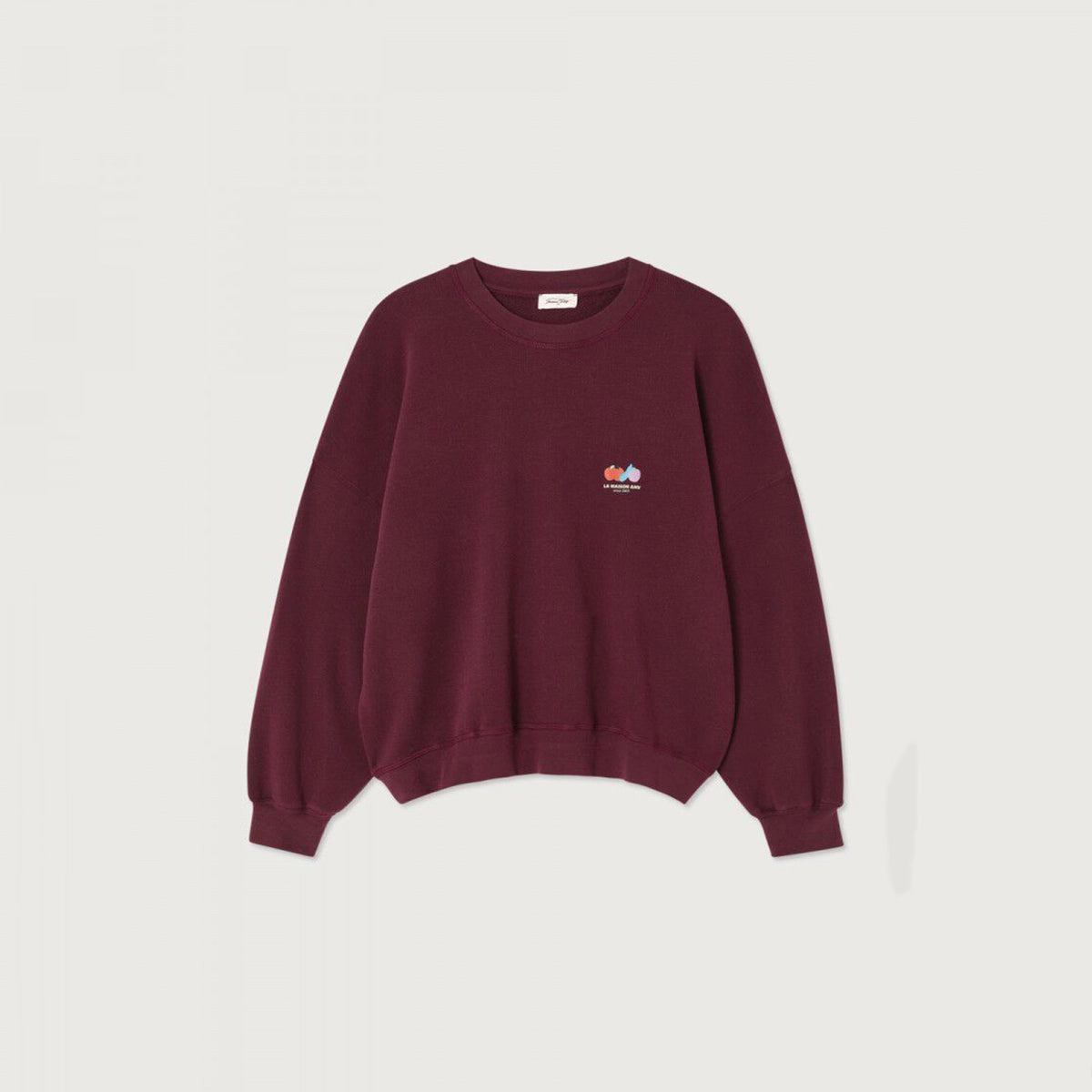 A deep burgundy crew neck sweatshirt with a logo on the right hand side, laid flat on a white background.