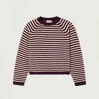 A cropped long-sleeve knit sweater with horizontal stripes in dark plum and cream, displayed flat against a light gray background.