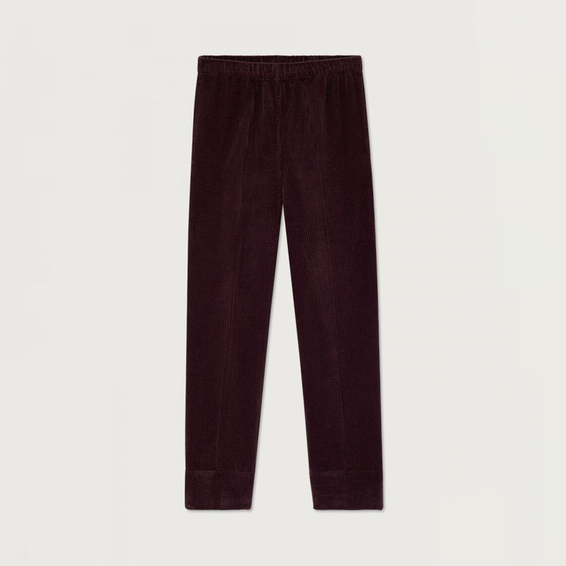 A pair of dark plum corduroy pants with an elastic waistband, shown flat against a light off-white background.