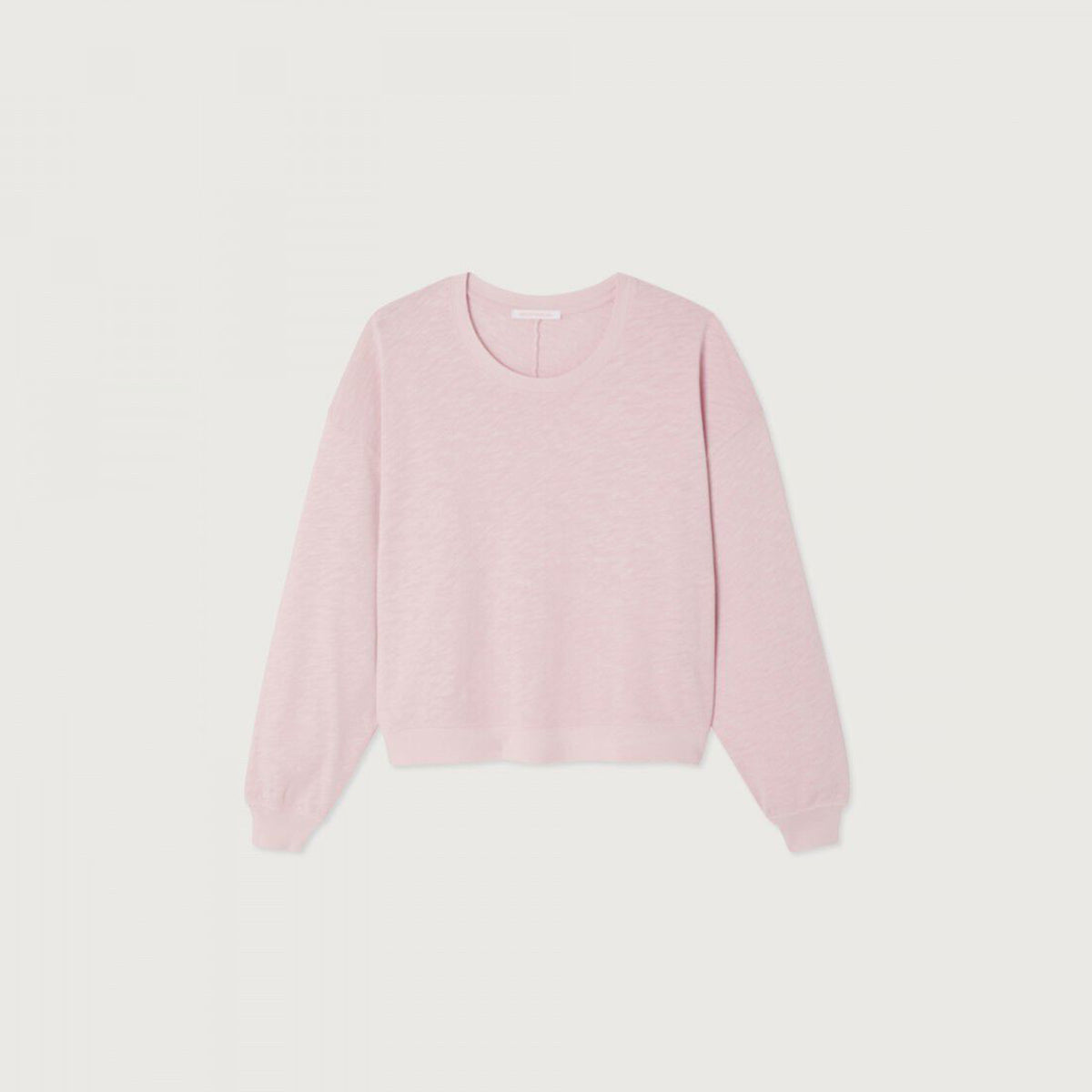 A light pink crewneck sweatshirt with long sleeves and ribbed cuffs, displayed flat against a light off-white background.