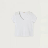 A white short-sleeve V-neck top laid flat against a light beige background.