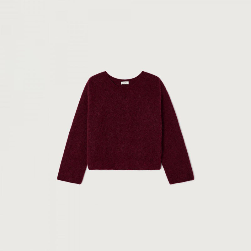 A long-sleeve crewneck sweater in a deep burgundy color, laid flat against a light off-white background.