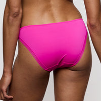 person wearing bright pink bikini bottoms on a plain background