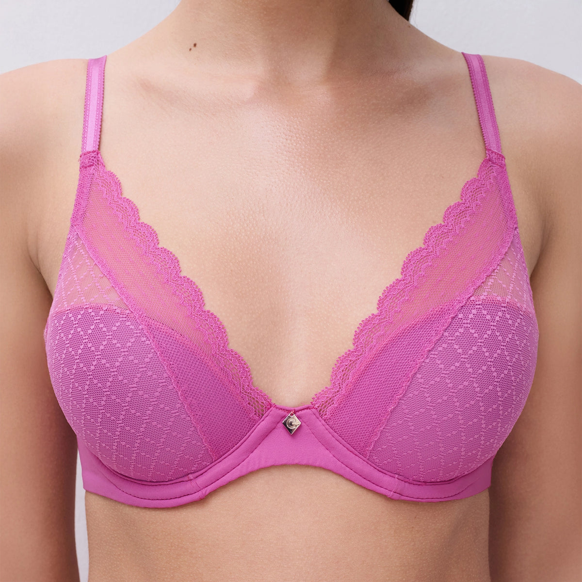 pink bra with lace details on a plain background