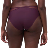 Rear view of a model wearing a pair of high-waisted, deep plum purple underwear with a sheer lace waistband, set against a plain white background.