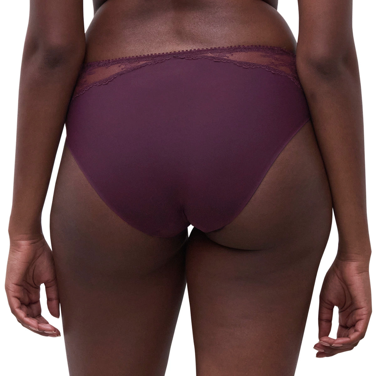Rear view of a model wearing a pair of high-waisted, deep plum purple underwear with a sheer lace waistband, set against a plain white background.