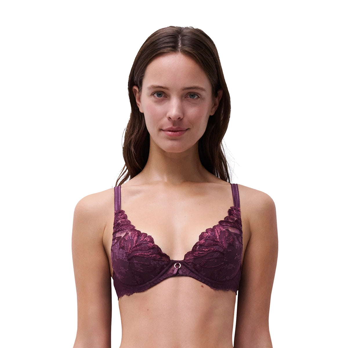 A woman modeling a dark plum lace bra against a solid white background.