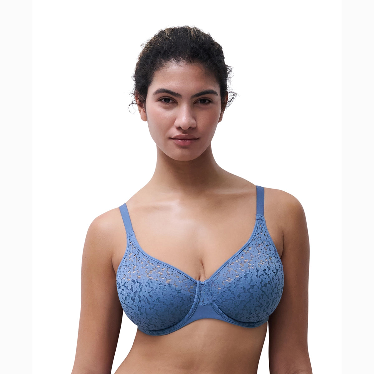woman wearing a blue lace bra against a white background