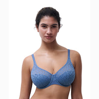 woman wearing a blue lace bra against a white background