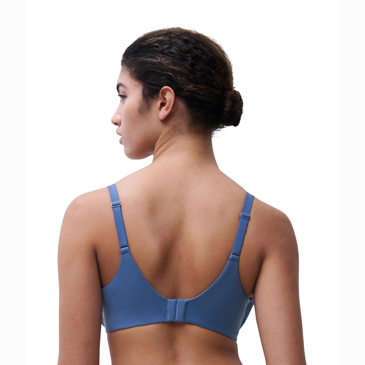 woman wearing a blue sports bra on a white background