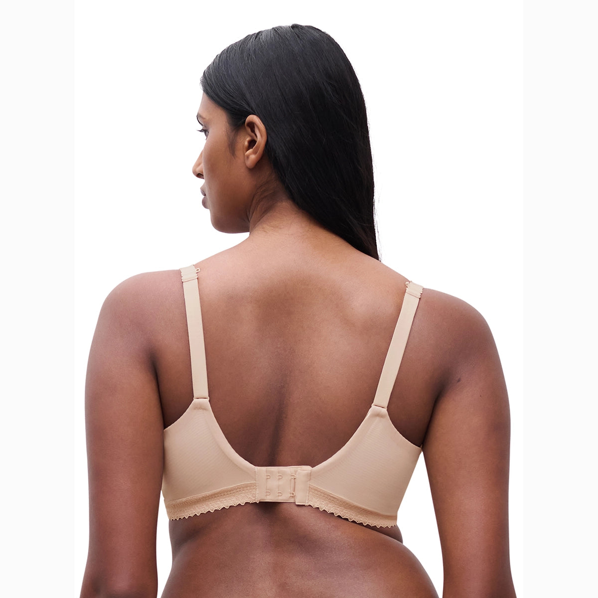 woman wearing a beige bra on a white background