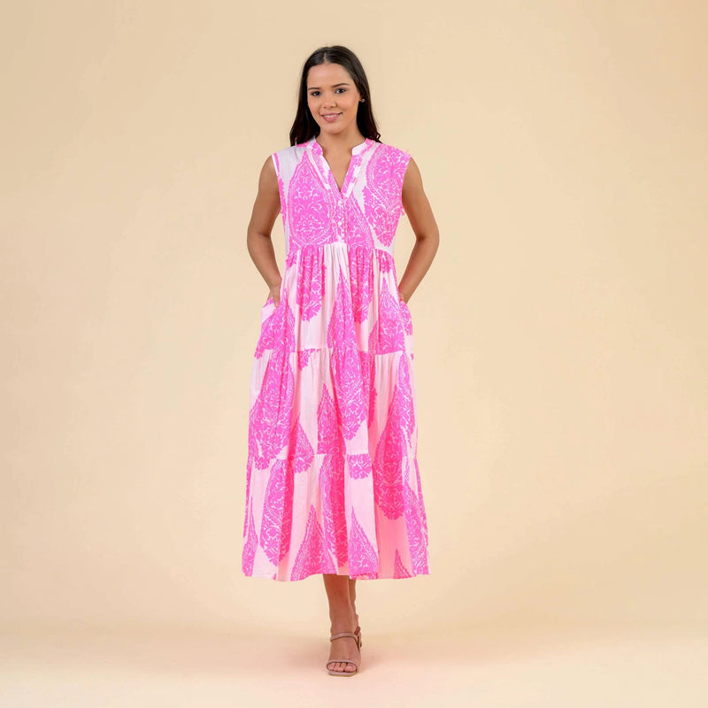 woman wearing a pink and white patterned dress on a beige background