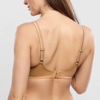 beige bra worn by a person on a light gray background