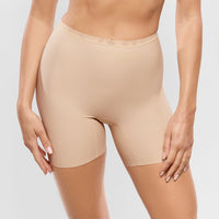 beige shapewear shorts worn by a person on a light grey background