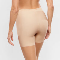 beige shapewear worn by a person on a plain background