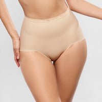 beige high-waisted underwear worn by a person on a light grey background