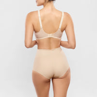 beige bodysuit worn by a model on a light grey background