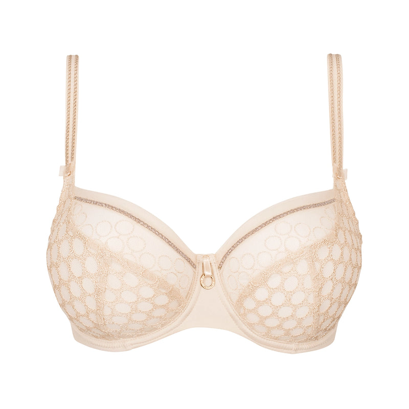 A beige underwire bra with a sheer floral lace pattern, featuring thin adjustable shoulder straps and a small gold ring closure at the center front, shown against a plain white background.