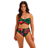 woman wearing a tropical leaf patterned bikini on a white background