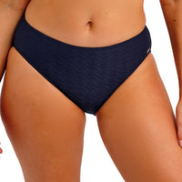 navy blue patterned bikini bottom on a person against a white background