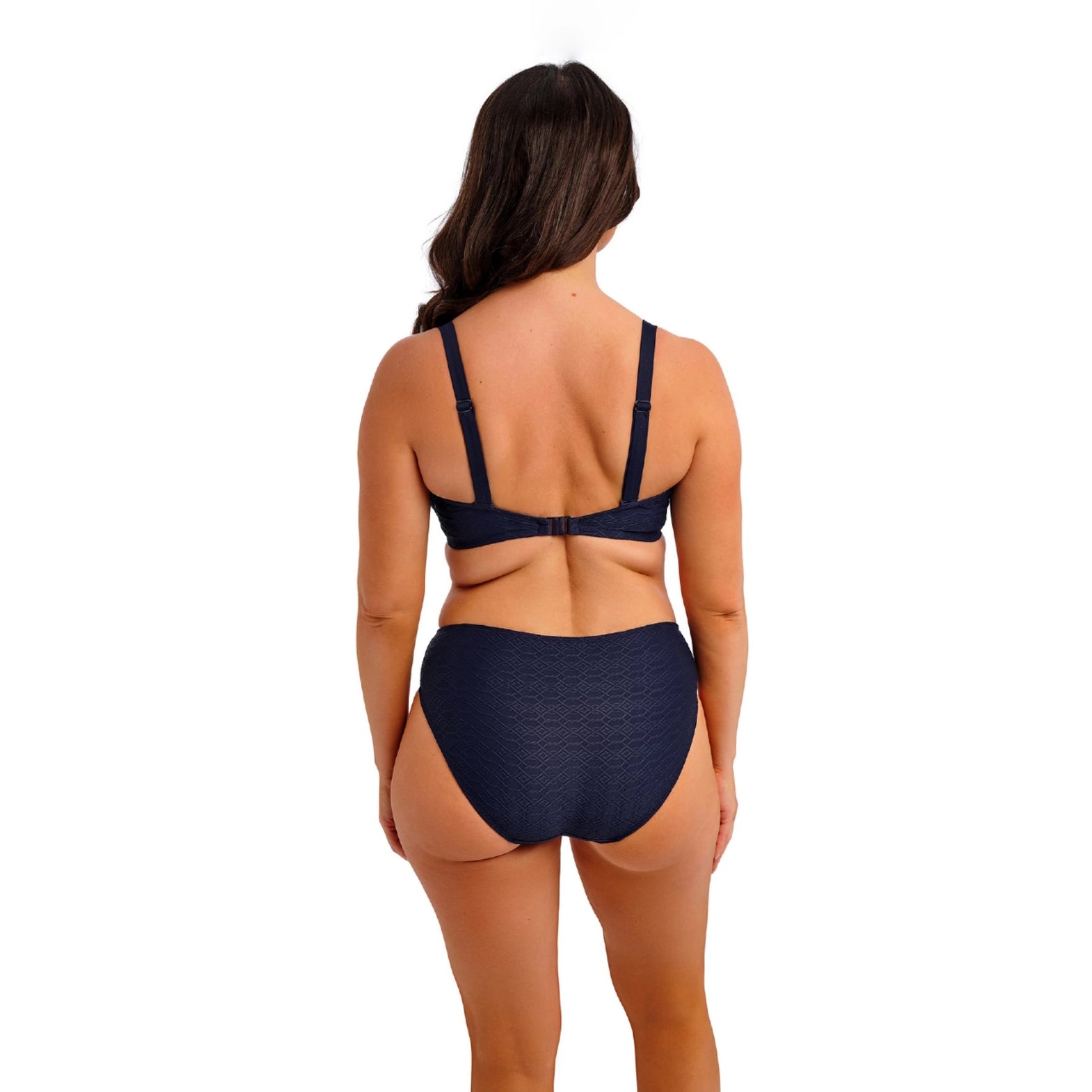 woman wearing a navy blue bikini set on a white background