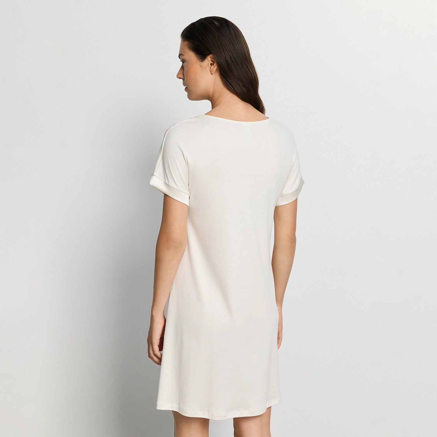 woman wearing hanro white nightdress against a plain background