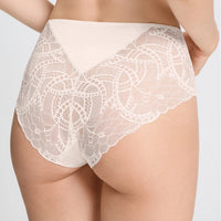 A close-up of a model wearing high-waisted white lace panties with a solid waistband, shown from the back against a light gray studio background.