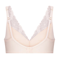 A light beige wireless bra with a delicate white lace overlay on the cups, featuring adjustable shoulder straps with gold-tone buckles, shown against a plain white background.