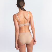 beige lingerie set on a plain background