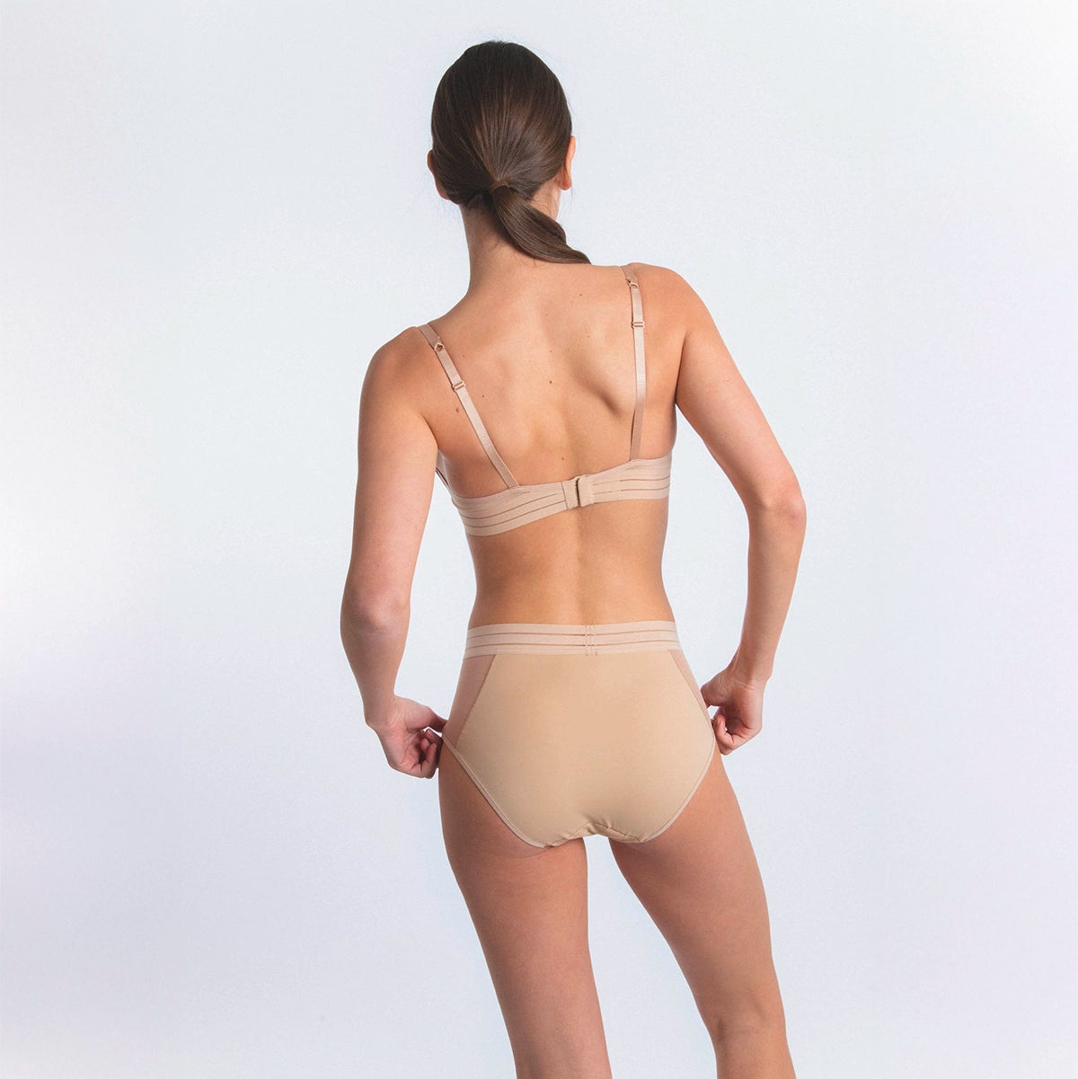 woman wearing beige lingerie on a white background