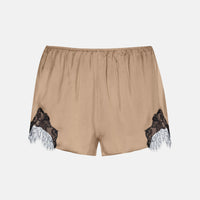 Beige satin shorts with black lace and white tulle trim at the hem, shown flat on a light gray background.