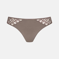 A pair of women's low-rise thong panties in a muted taupe-brown color, featuring intricate floral lace applique on the hip straps, shown against a plain light gray background.