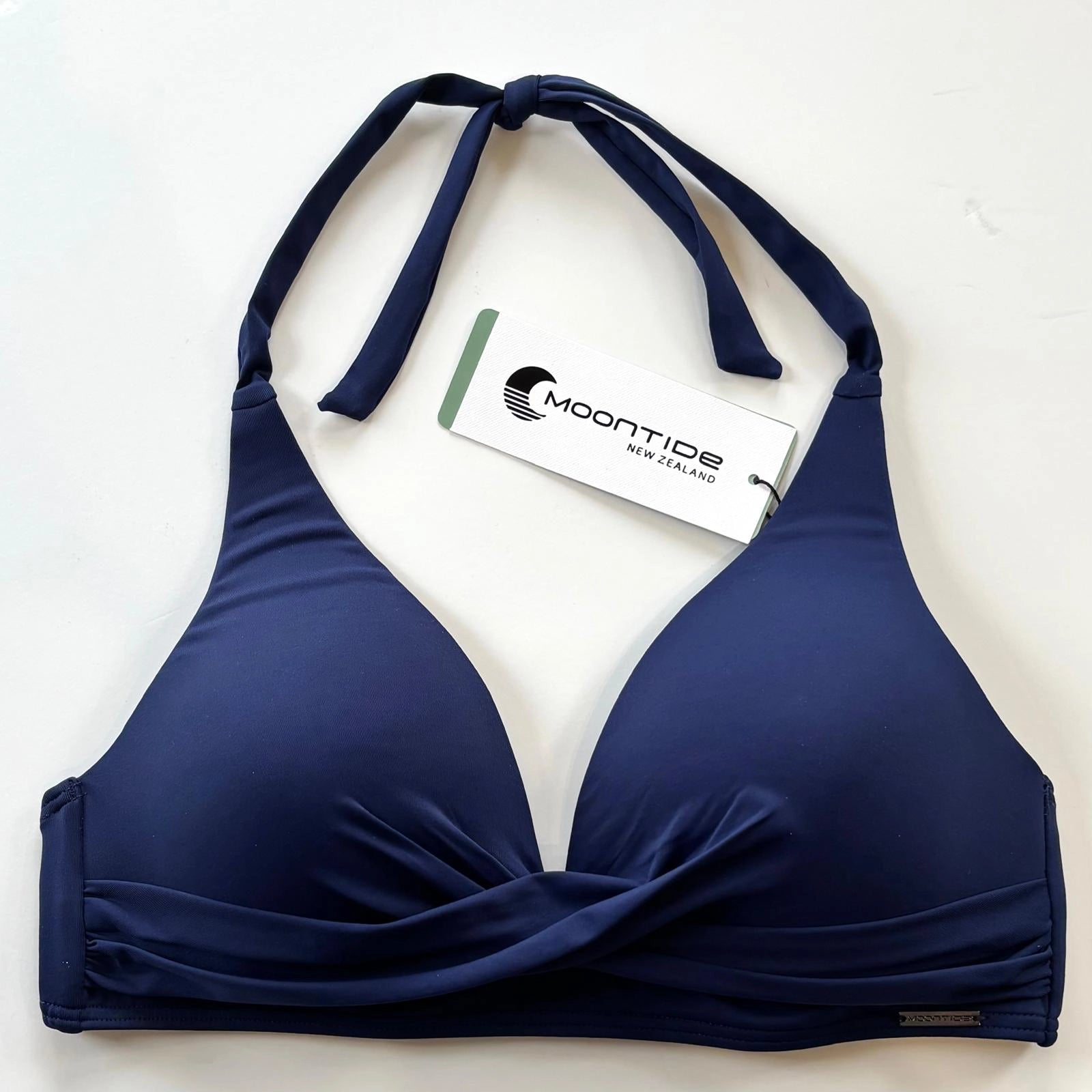 navy blue bikini top with 'Moontide' tag on a white background