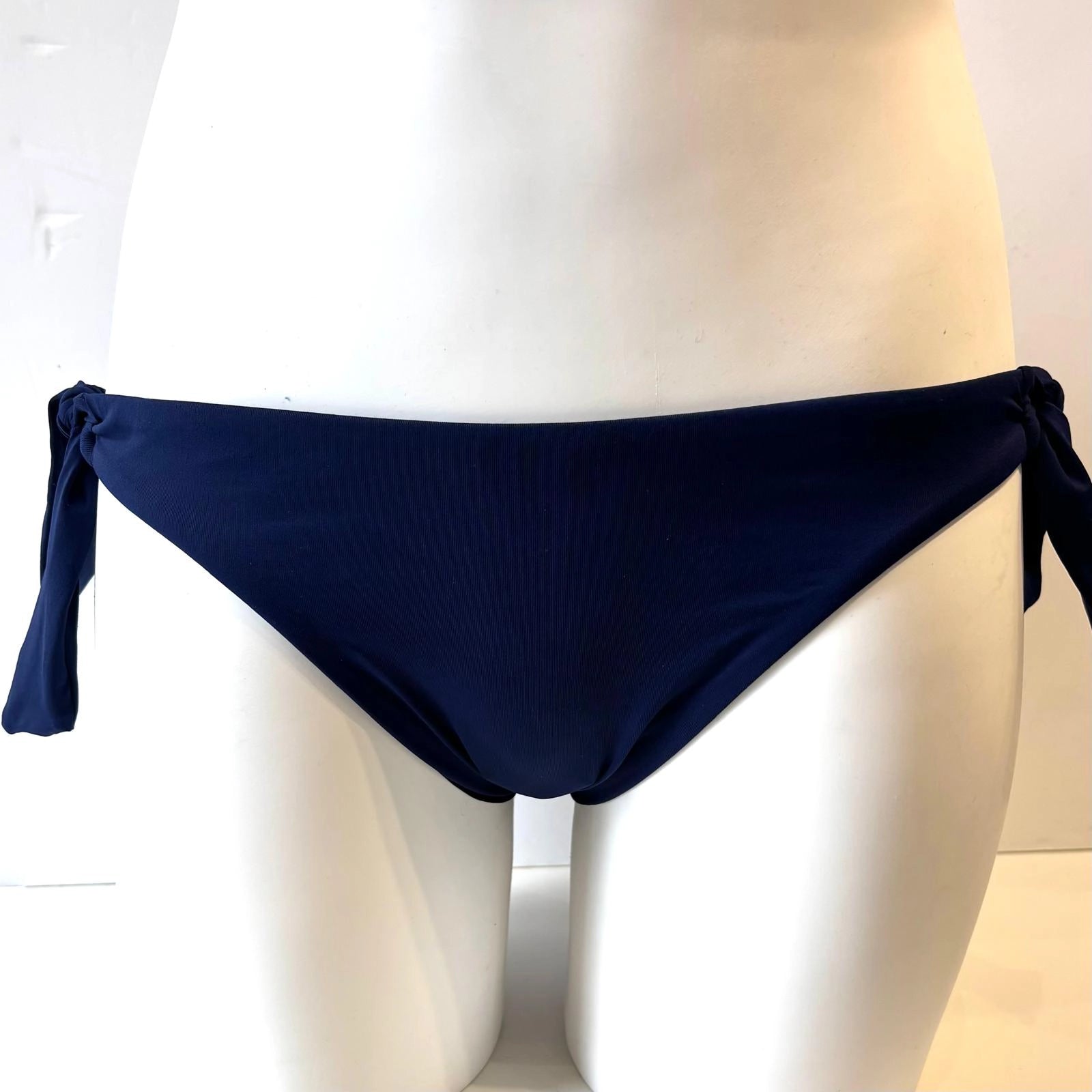 navy blue bikini bottom on a mannequin against a white background