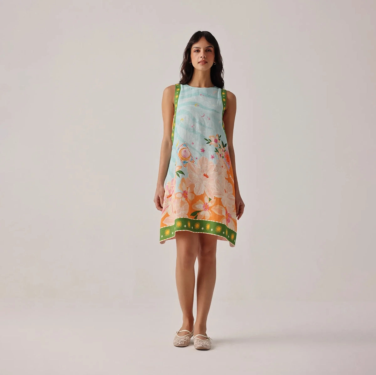 woman wearing a floral dress on a plain background